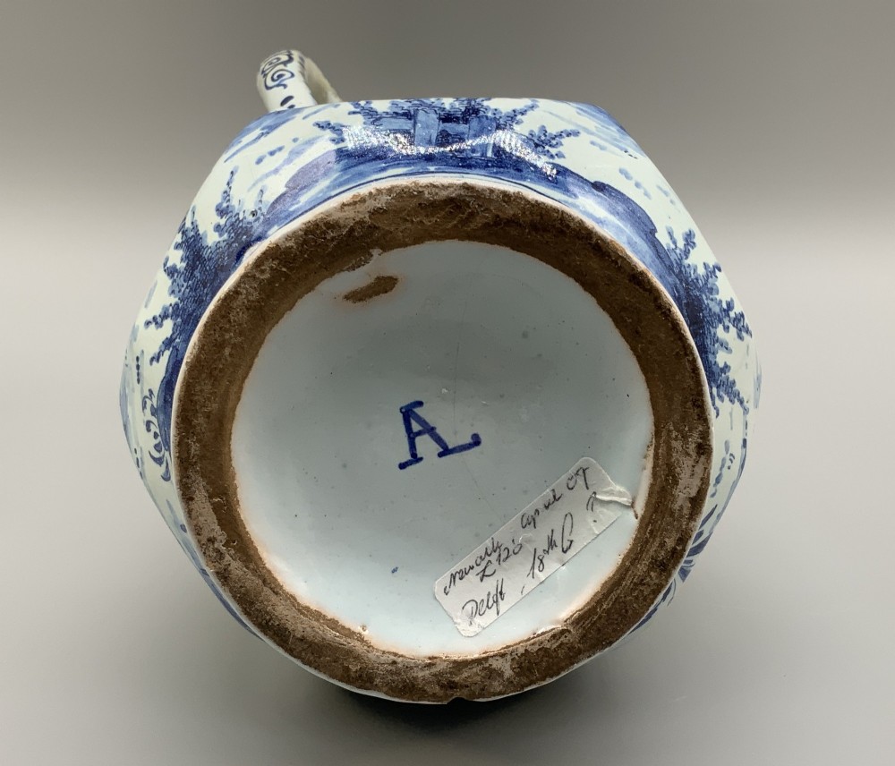 An eighteenth-century blue and white Dutch Delftware ceramic jug decorated with hand-painted figures, complete with a fitted pewter lid. View XV