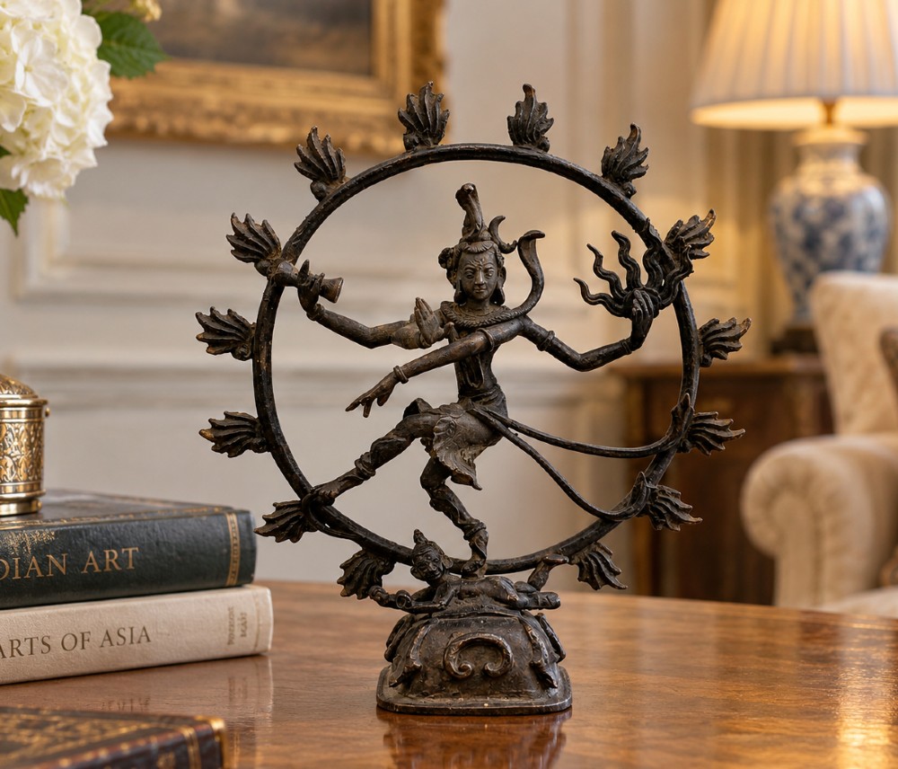 A dark patinated bronze 19th-century figure of Shiva Nataraja dancing within a circular halo of flames atop a lotus pedestal. View II