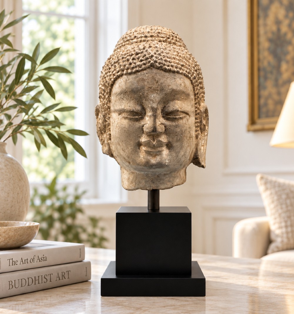 A carved limestone Chinese Buddha head featuring downcast eyes, elongated earlobes, and coiled hair, mounted on a black square stand. View II
