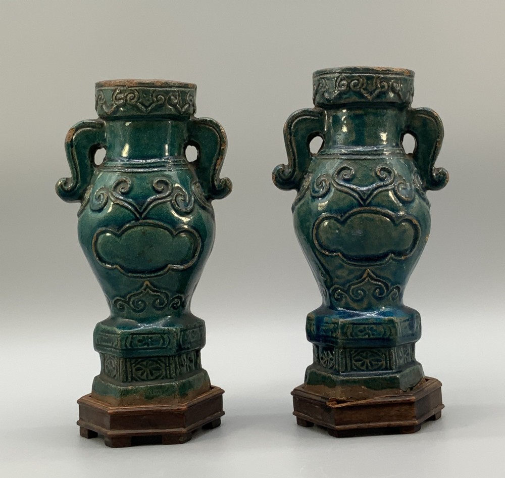 A pair of early seventeenth-century Chinese ceramic vases featuring turquoise glaze, amber reserves, relief scrollwork, and wooden bases. View VII