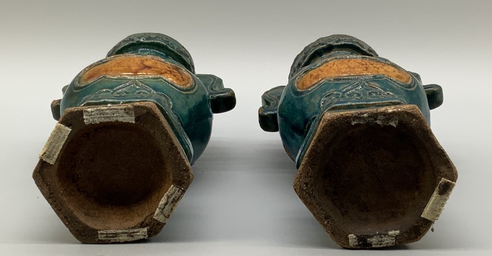 A pair of early seventeenth-century Chinese ceramic vases featuring turquoise glaze, amber reserves, relief scrollwork, and wooden bases. View XII