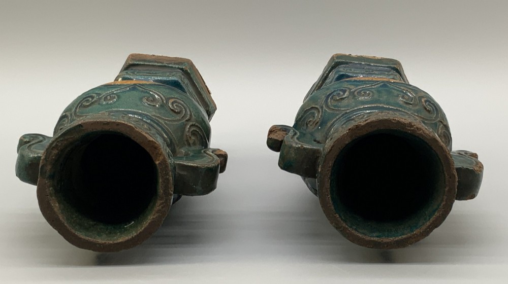 A pair of early seventeenth-century Chinese ceramic vases featuring turquoise glaze, amber reserves, relief scrollwork, and wooden bases. View XIII