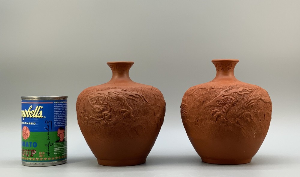 A pair of unglazed terracotta red clay vases featuring detailed relief carvings of dragons with narrow flared necks. View III