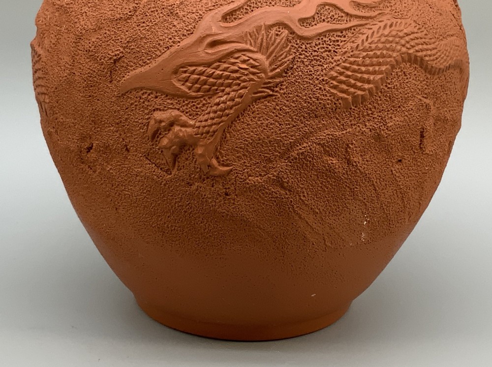 A pair of unglazed terracotta red clay vases featuring detailed relief carvings of dragons with narrow flared necks. View VII