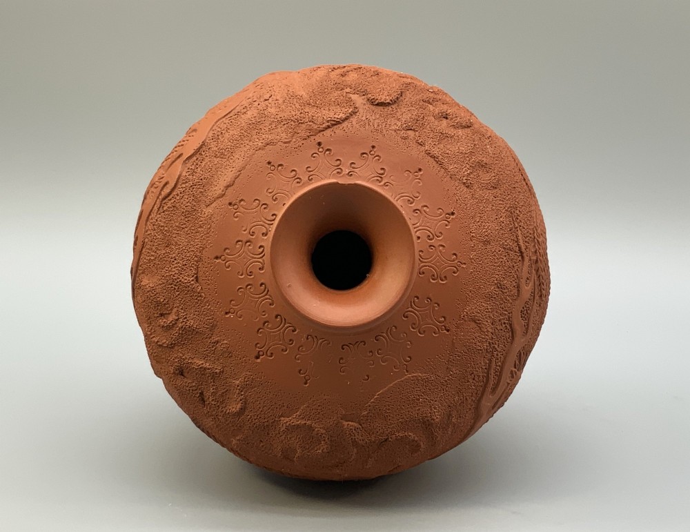 A pair of unglazed terracotta red clay vases featuring detailed relief carvings of dragons with narrow flared necks. View IX