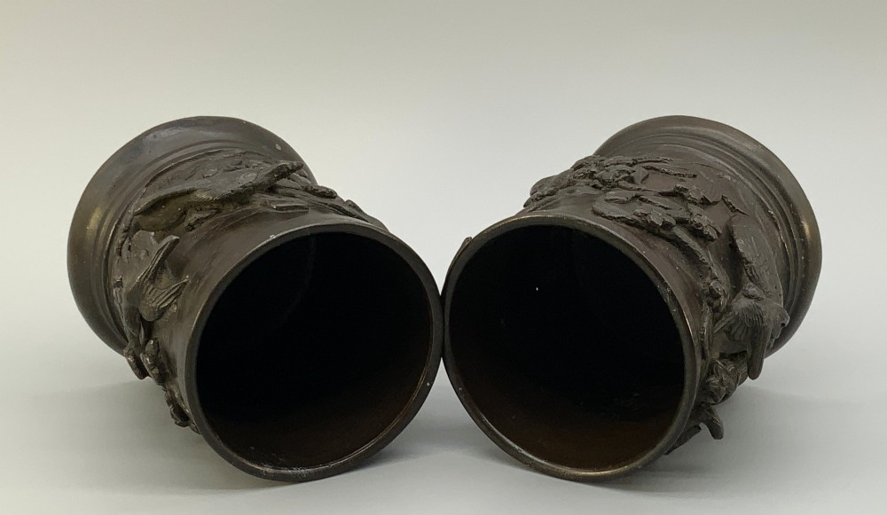 A pair of cylindrical dark patinated bronze vases featuring raised relief depictions of birds perched amongst cherry blossom branches. View IX