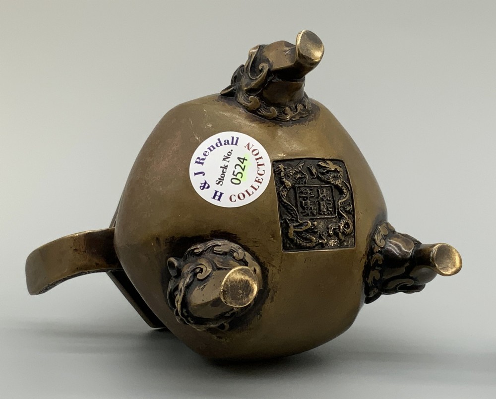 A late Qing dynasty hexagonal bronze tripod censer featuring upright side handles, a removable cover topped with a mythical beast finial, and feet shaped as animal masks. View XII