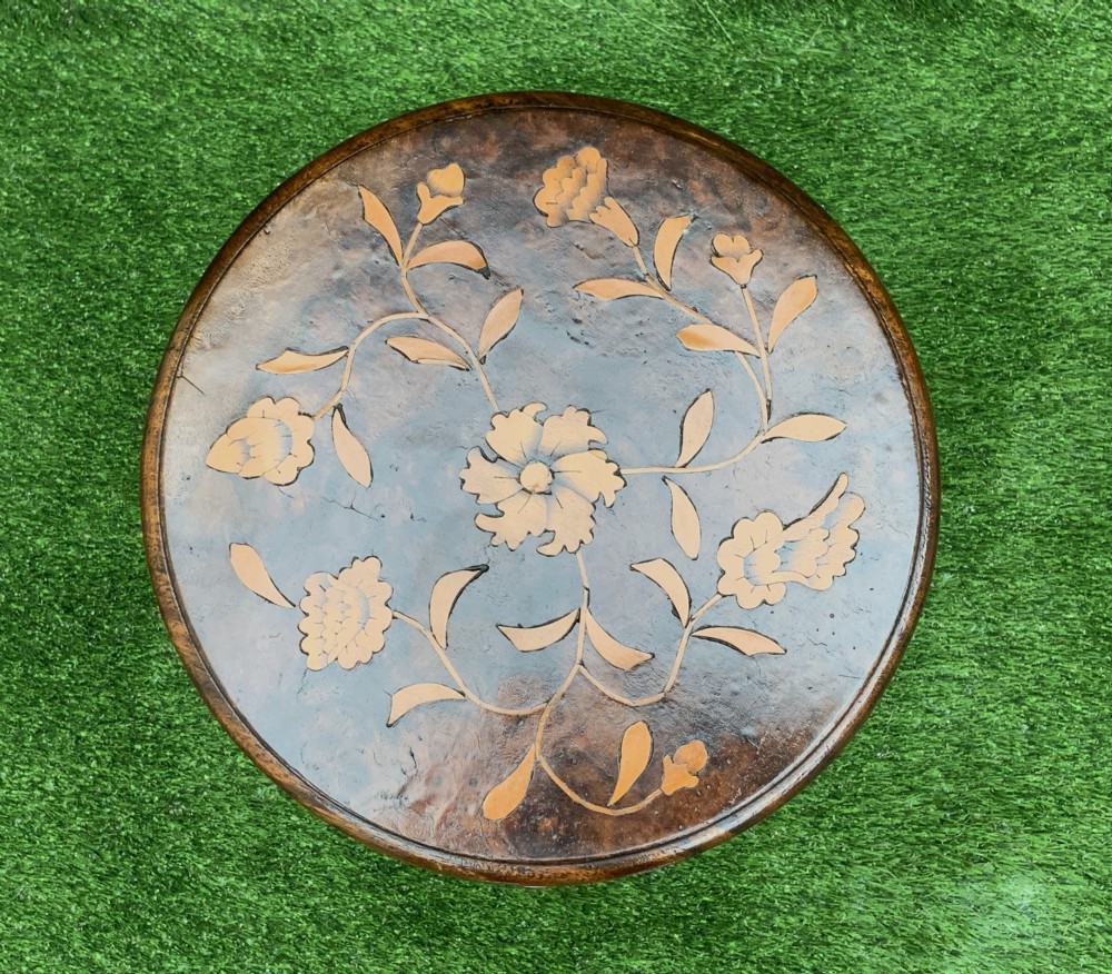 A 19th-century Dutch marquetry wine table featuring a circular floral-inlaid top, a carved central column, and a shaped triform base raised on bun feet. View IV