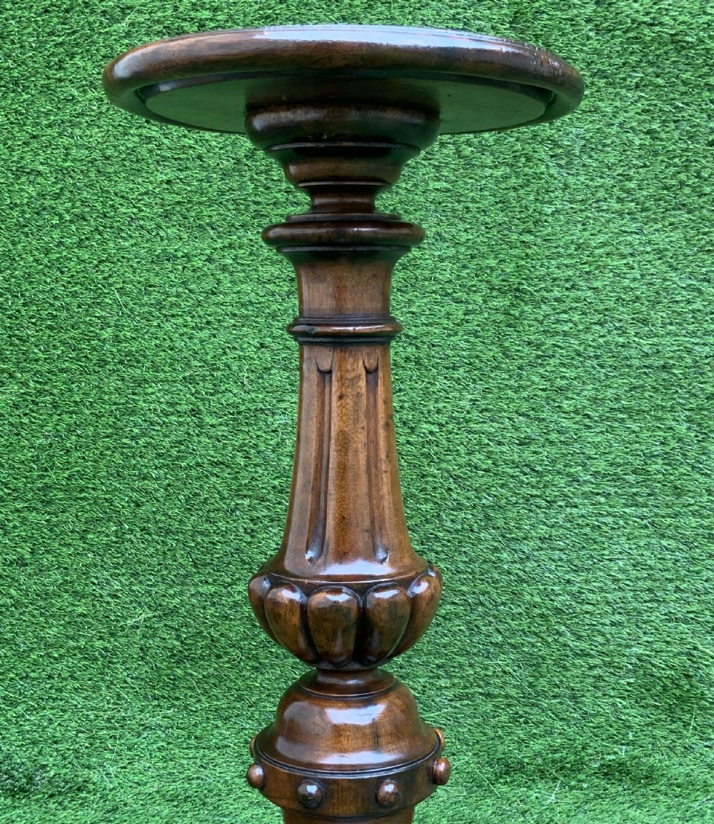 A 19th-century Dutch marquetry wine table featuring a circular floral-inlaid top, a carved central column, and a shaped triform base raised on bun feet. View VI