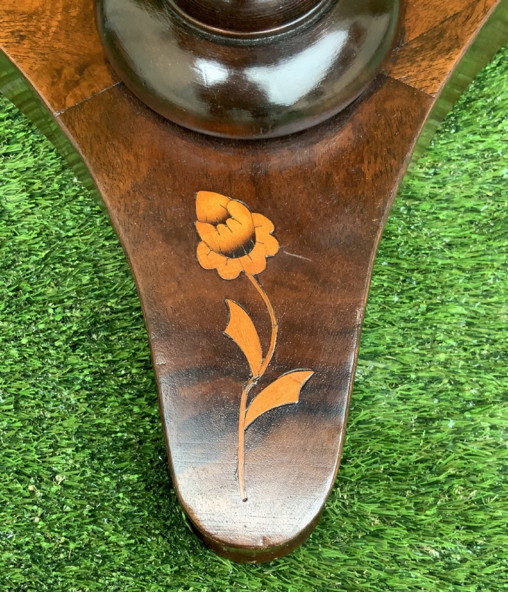 A 19th-century Dutch marquetry wine table featuring a circular floral-inlaid top, a carved central column, and a shaped triform base raised on bun feet. View XI