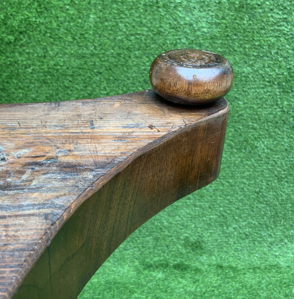 A 19th-century Dutch marquetry wine table featuring a circular floral-inlaid top, a carved central column, and a shaped triform base raised on bun feet. View XII