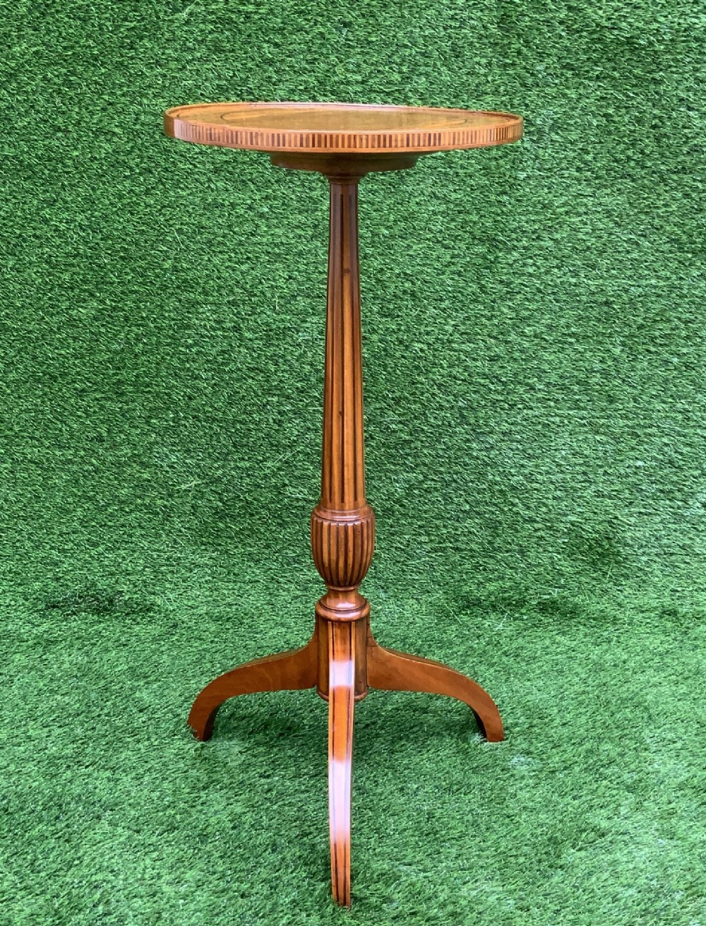 A 19th-century satinwood wine table featuring a circular top with inlaid marquetry detailing, supported by a fluted central pedestal and three downswept tripod legs. View III