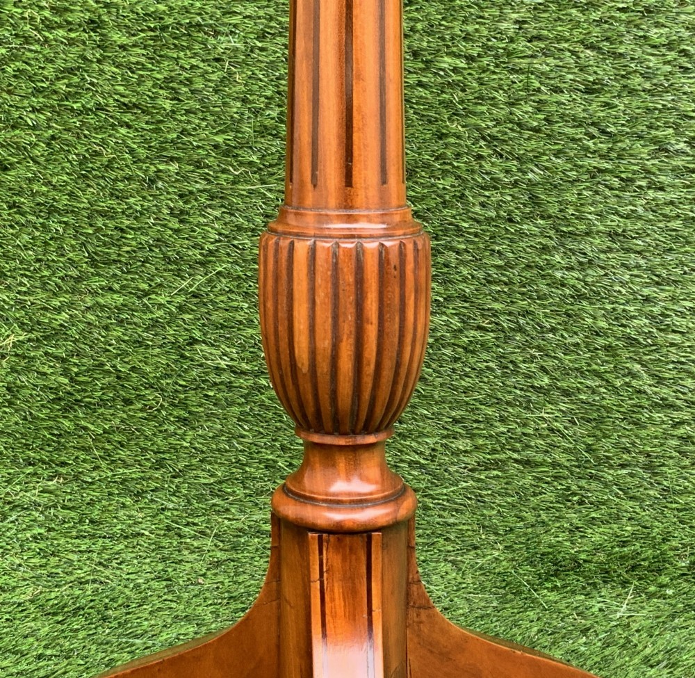 A 19th-century satinwood wine table featuring a circular top with inlaid marquetry detailing, supported by a fluted central pedestal and three downswept tripod legs. View VII