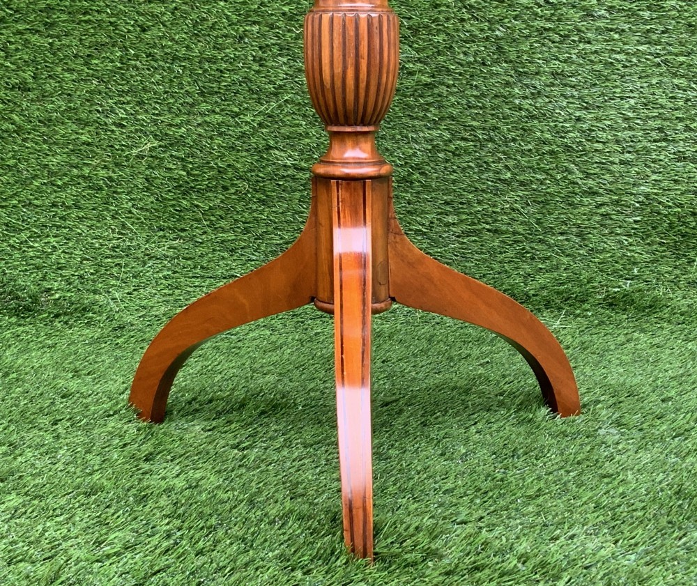 A 19th-century satinwood wine table featuring a circular top with inlaid marquetry detailing, supported by a fluted central pedestal and three downswept tripod legs. View VIII