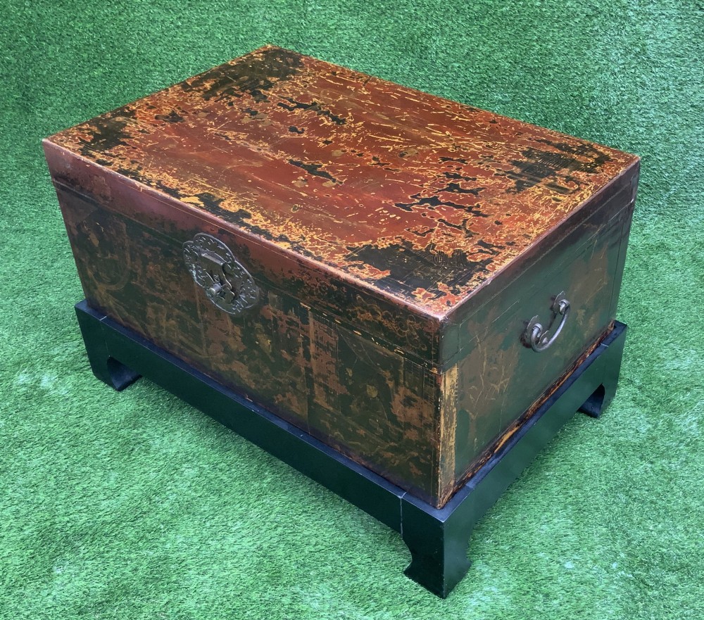 A large rectangular Japanese lacquered storage chest with gilt figurative Chinoiserie scenes set upon a black painted wooden stand. View II