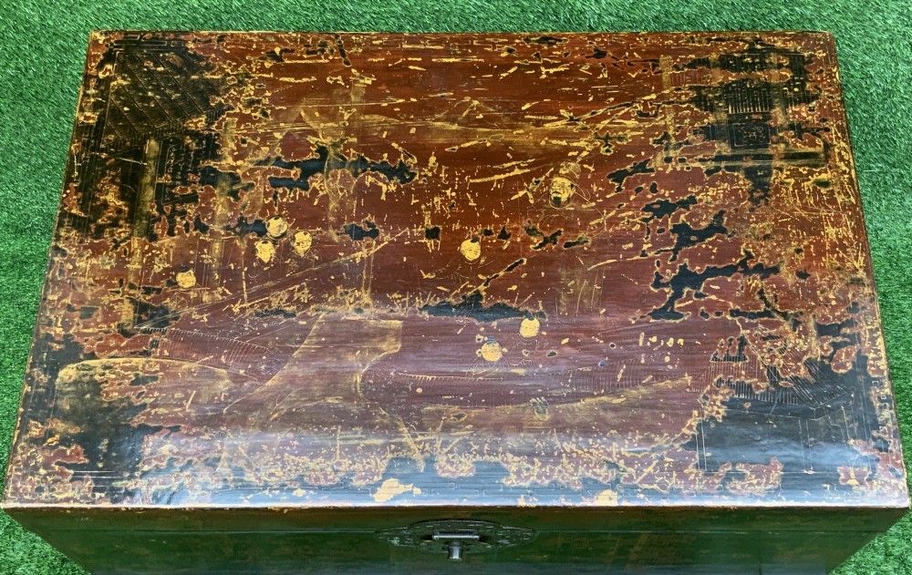 A large rectangular Japanese lacquered storage chest with gilt figurative Chinoiserie scenes set upon a black painted wooden stand. View IV