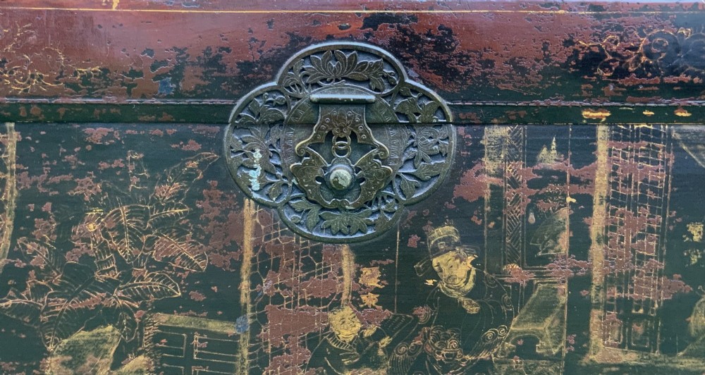 A large rectangular Japanese lacquered storage chest with gilt figurative Chinoiserie scenes set upon a black painted wooden stand. View V