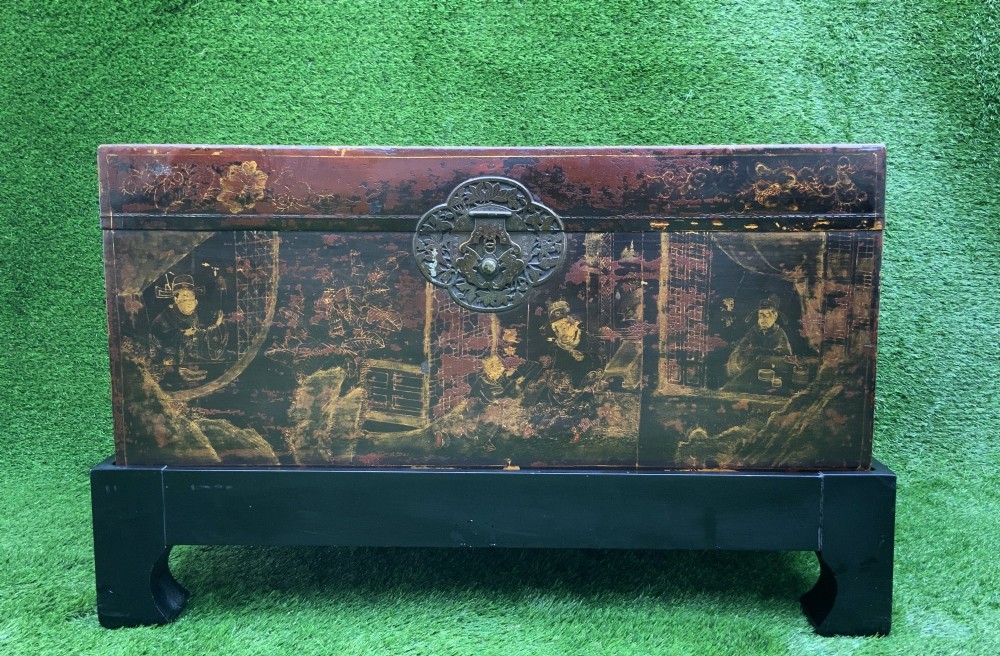 A large rectangular Japanese lacquered storage chest with gilt figurative Chinoiserie scenes set upon a black painted wooden stand. View VI