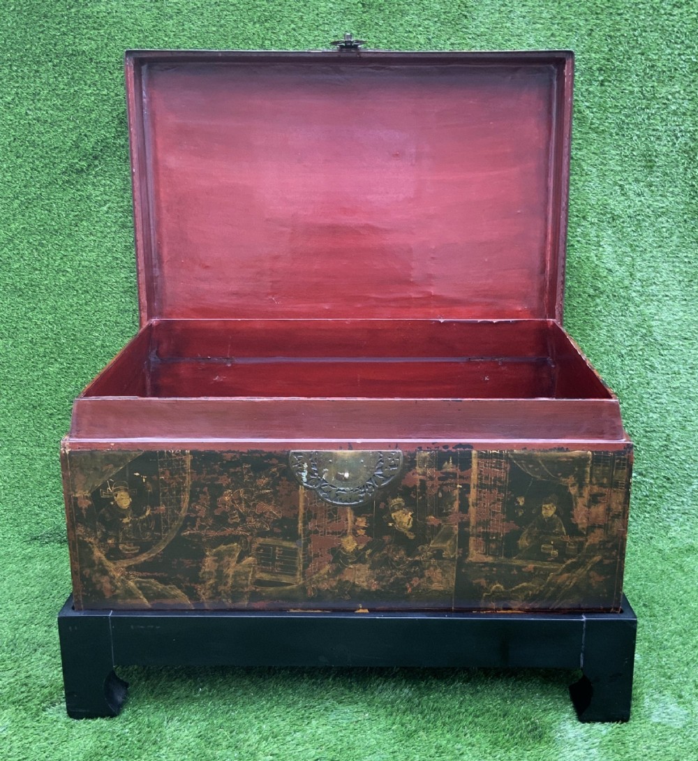 A large rectangular Japanese lacquered storage chest with gilt figurative Chinoiserie scenes set upon a black painted wooden stand. View VII