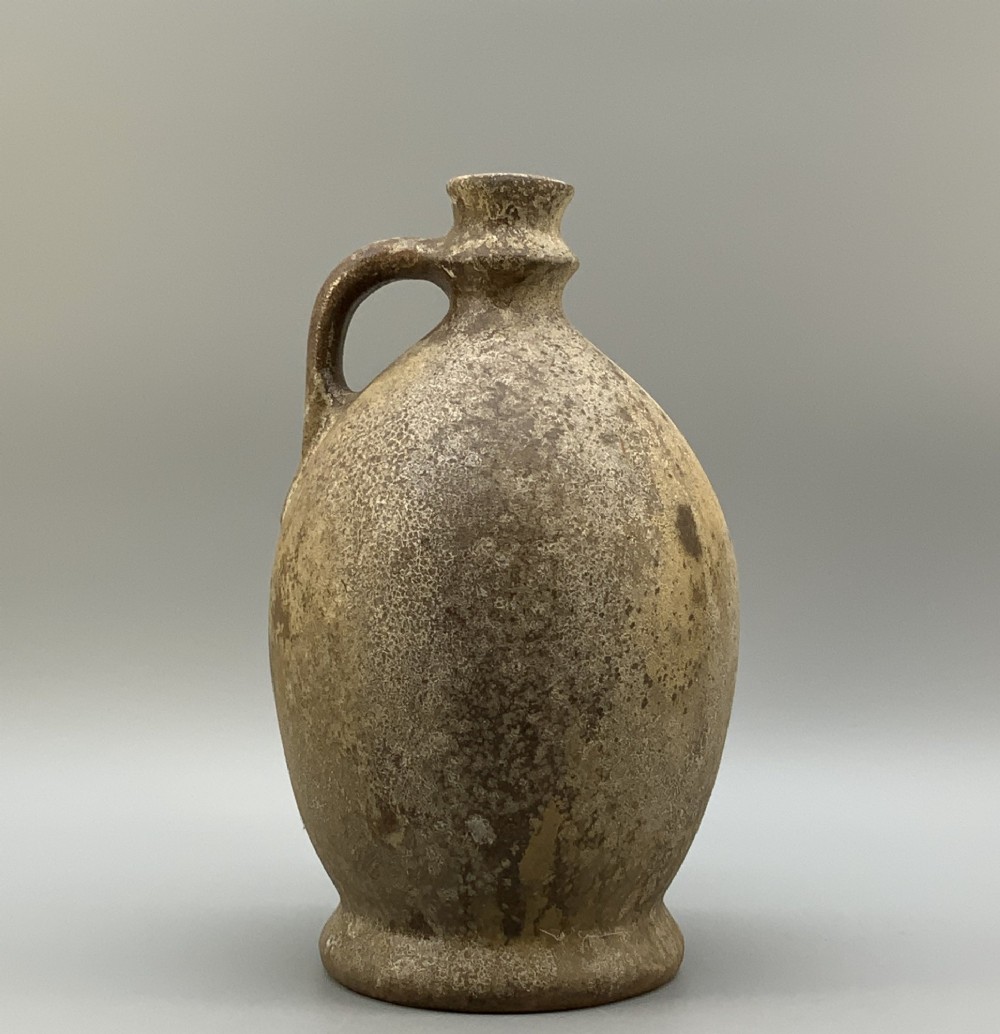A 19th-century salt-glazed stoneware flagon featuring a mottled brown textured surface, narrow neck, flared rim, and a single loop handle. View II