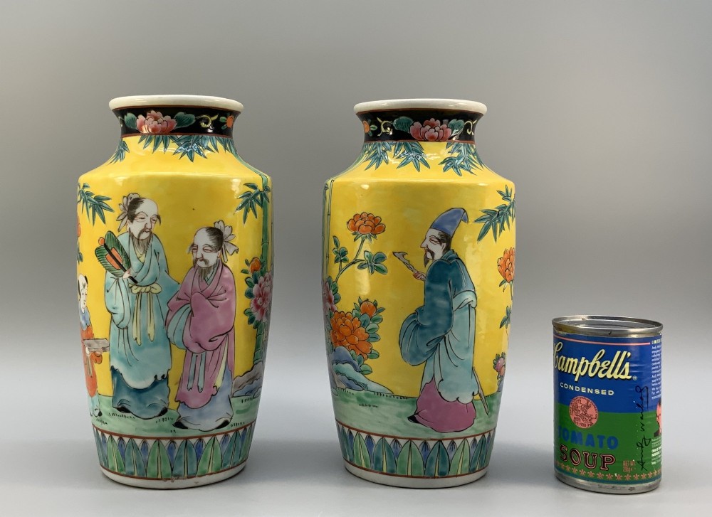 A pair of yellow ground Chinese porcelain vases decorated with painted figures, floral motifs, and green leaf borders around the base. View III
