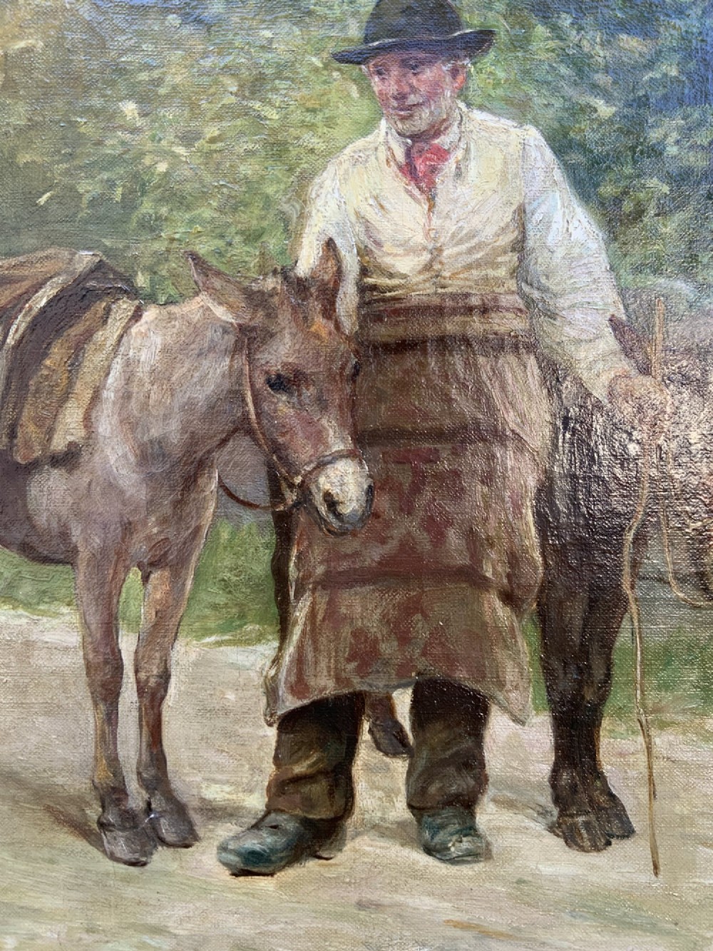 A nineteenth-century Victorian oil painting depicting a rural scene with figures and donkeys, housed inside an ornate carved giltwood frame. View X