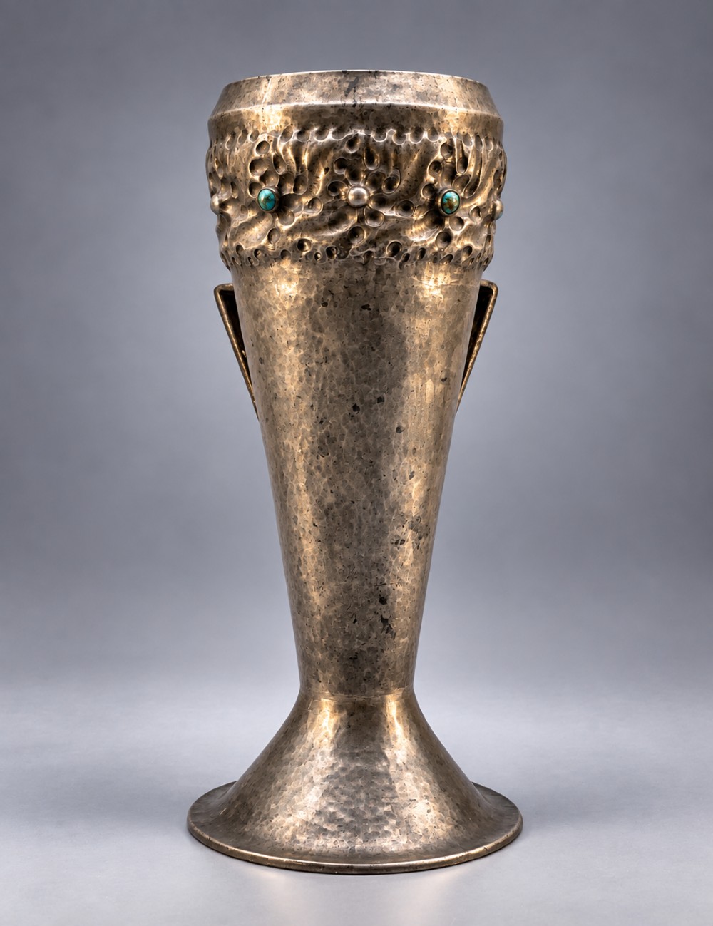 An Arts and Crafts hammered pewter vase featuring raised geometric support fins, a textured upper band, and inlaid turquoise cabochons. View IV
