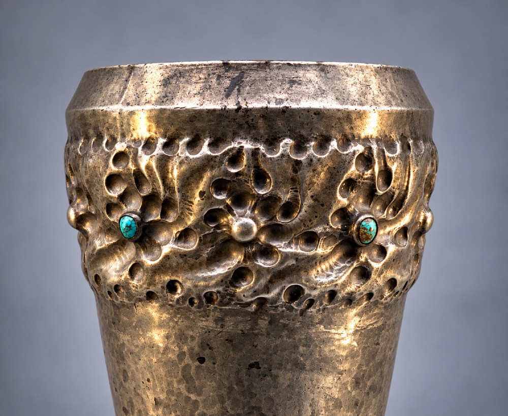 An Arts and Crafts hammered pewter vase featuring raised geometric support fins, a textured upper band, and inlaid turquoise cabochons. View VII