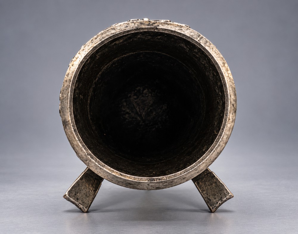 An Arts and Crafts hammered pewter vase featuring raised geometric support fins, a textured upper band, and inlaid turquoise cabochons. View X
