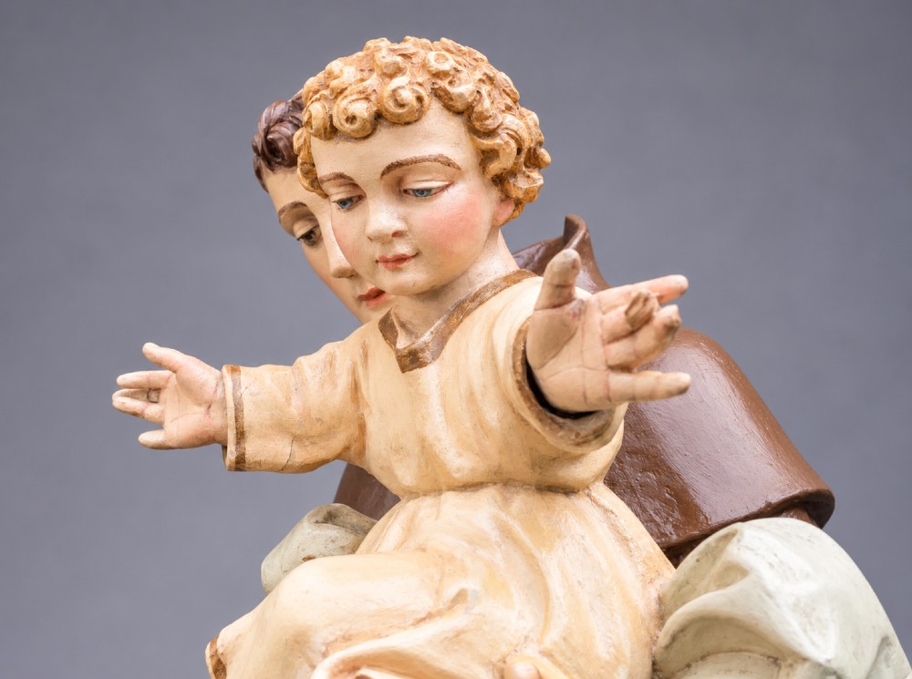 An antique polychrome carved wood sculpture depicting Saint Anthony in a brown Franciscan habit holding the Christ Child. View IX