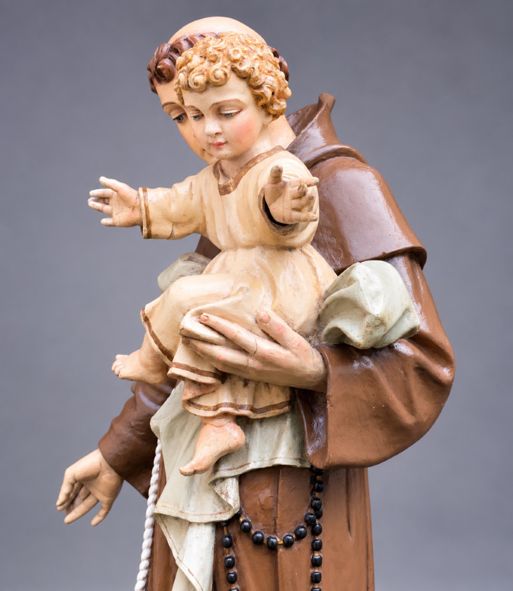 An antique polychrome carved wood sculpture depicting Saint Anthony in a brown Franciscan habit holding the Christ Child. View X