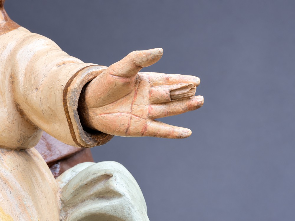 An antique polychrome carved wood sculpture depicting Saint Anthony in a brown Franciscan habit holding the Christ Child. View XIV