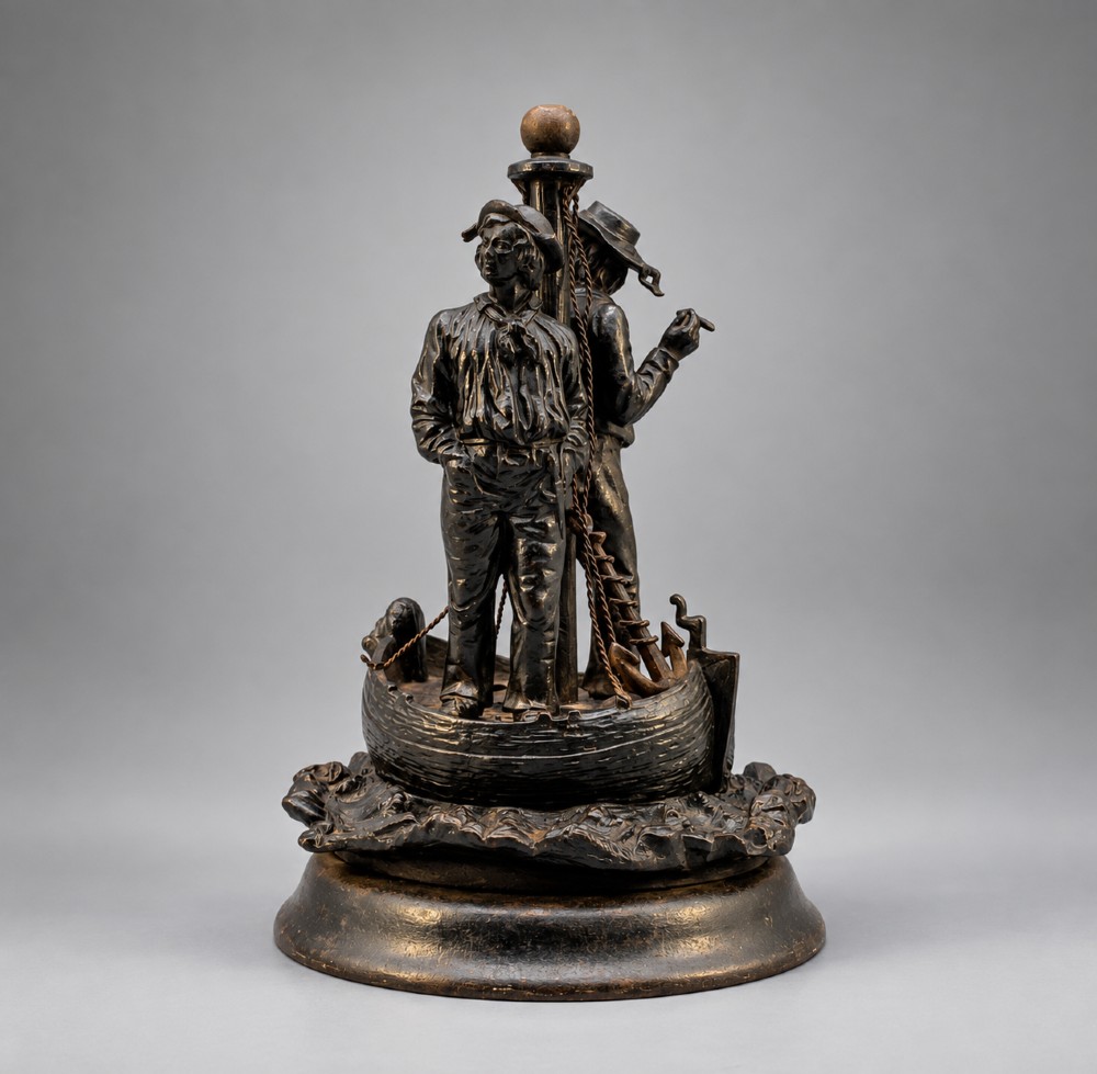 A nineteenth-century dark patinated bronze sculpture depicting two fishermen standing in a small vessel atop sculpted ocean waves, mounted on a rounded base.