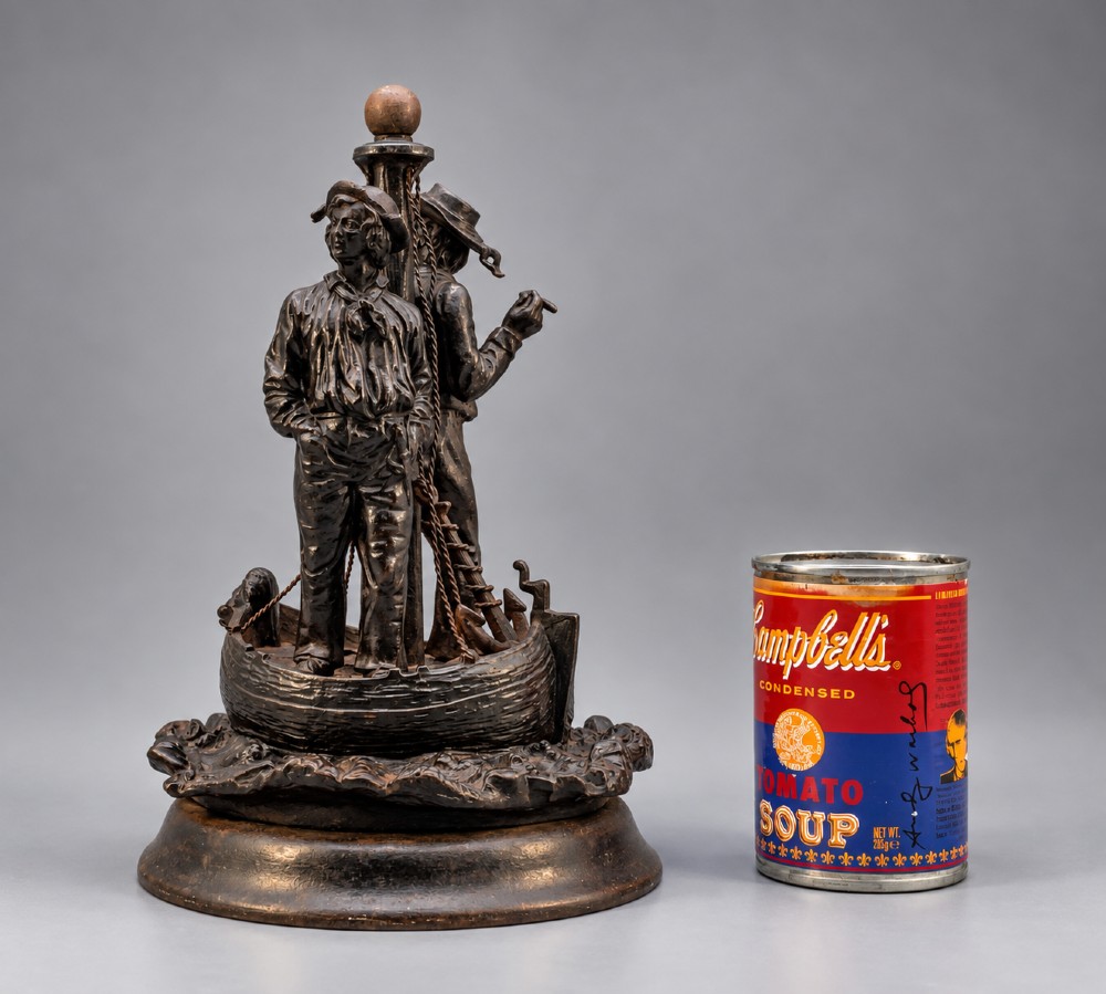 A nineteenth-century dark patinated bronze sculpture depicting two fishermen standing in a small vessel atop sculpted ocean waves, mounted on a rounded base. View II