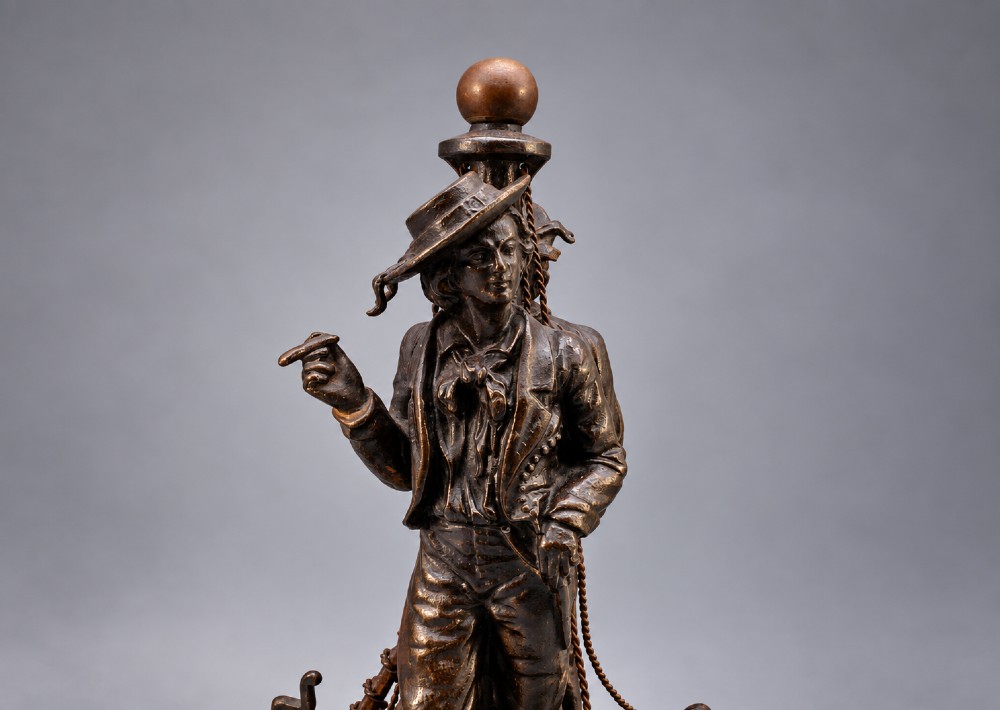 A nineteenth-century dark patinated bronze sculpture depicting two fishermen standing in a small vessel atop sculpted ocean waves, mounted on a rounded base. View VI