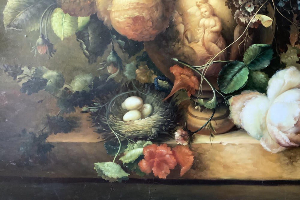A large scale oil painting featuring a dense arrangement of colourful flowers in a carved classical urn set within a painted stone archway. View VII