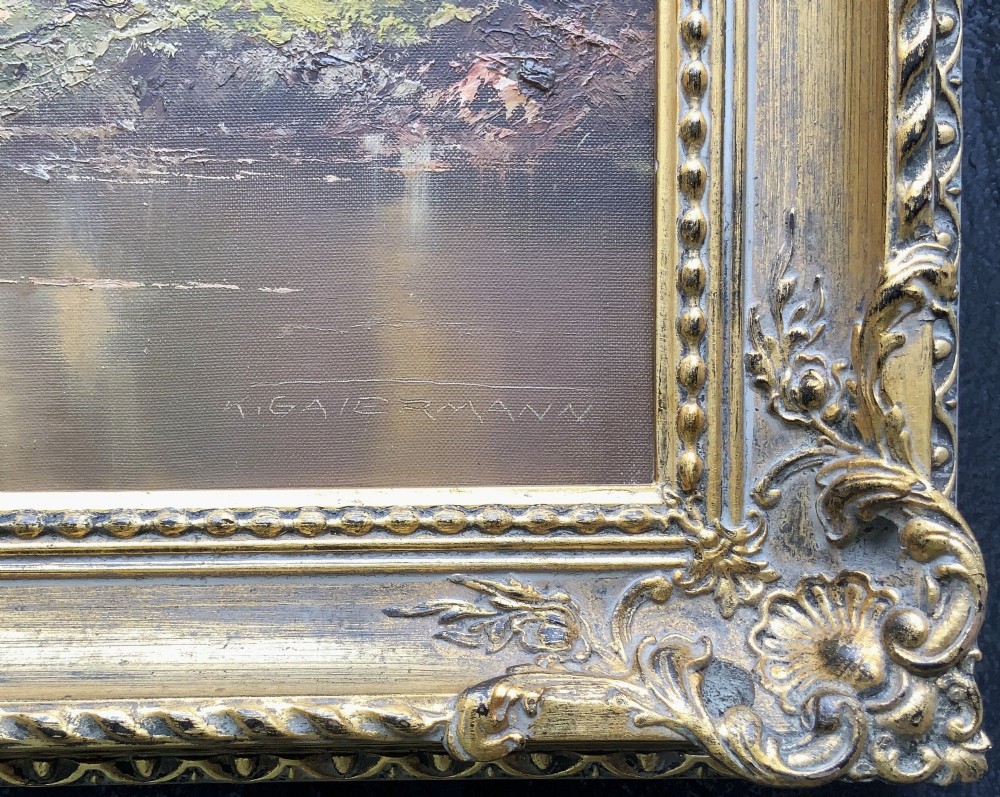 An original alpine landscape oil painting depicting mountains, rural cottages, and a pond reflection, set within an ornate gilded frame. View X