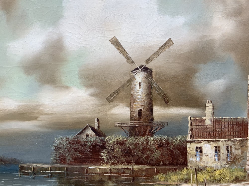 A horizontal oil painting depicting Dutch windmills and stone buildings along a riverbank under a cloudy sky, presented in an ornate gilt frame. View VII