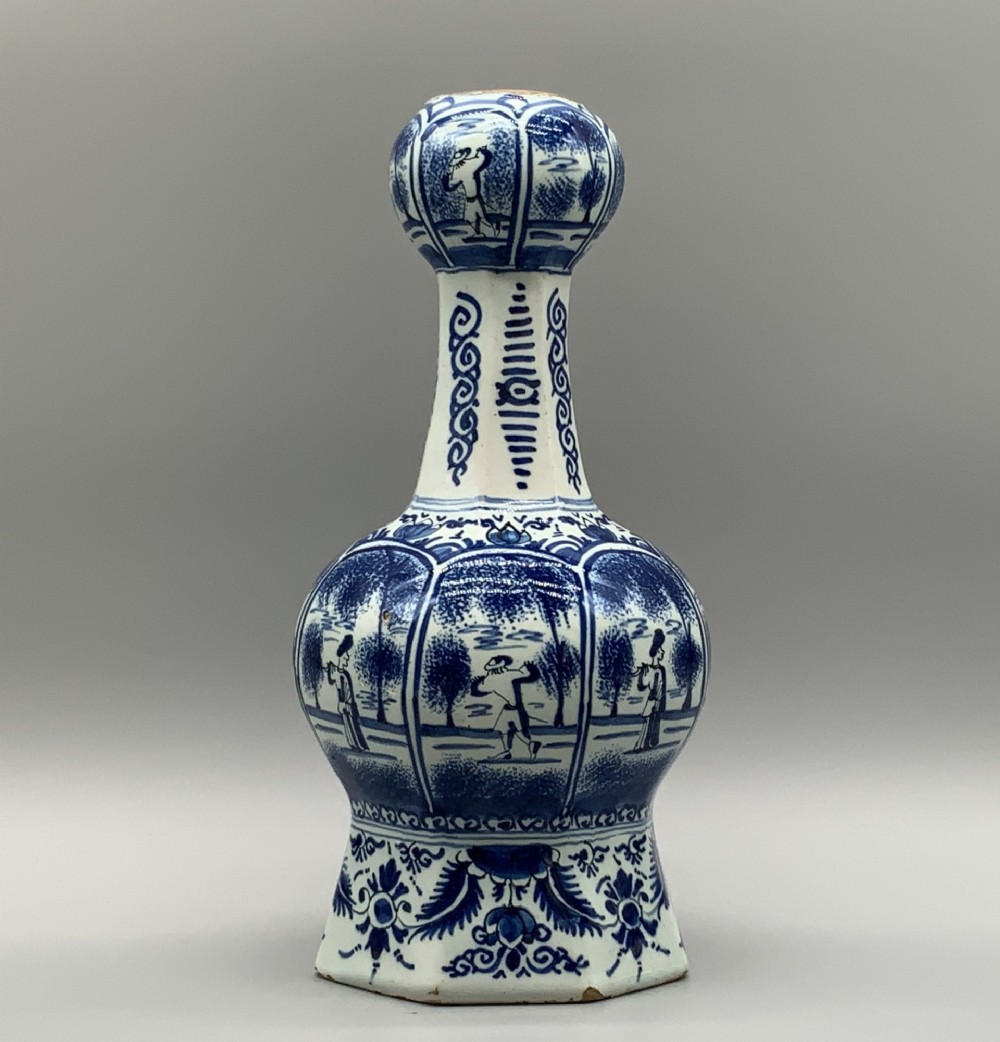 A 17th-century hexagonal Dutch Delft blue and white faience vase decorated with hand-painted chinoiserie figures and floral motifs. View III