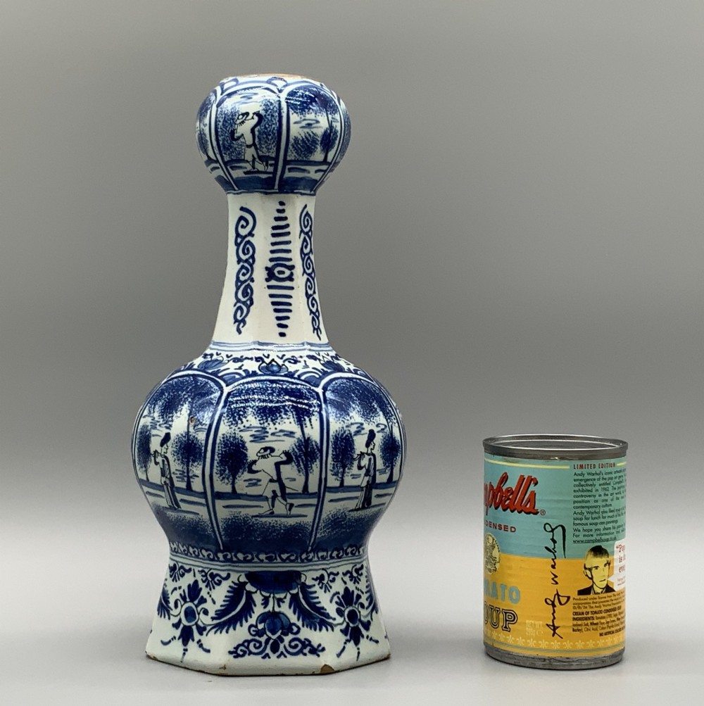 A 17th-century hexagonal Dutch Delft blue and white faience vase decorated with hand-painted chinoiserie figures and floral motifs. View IV