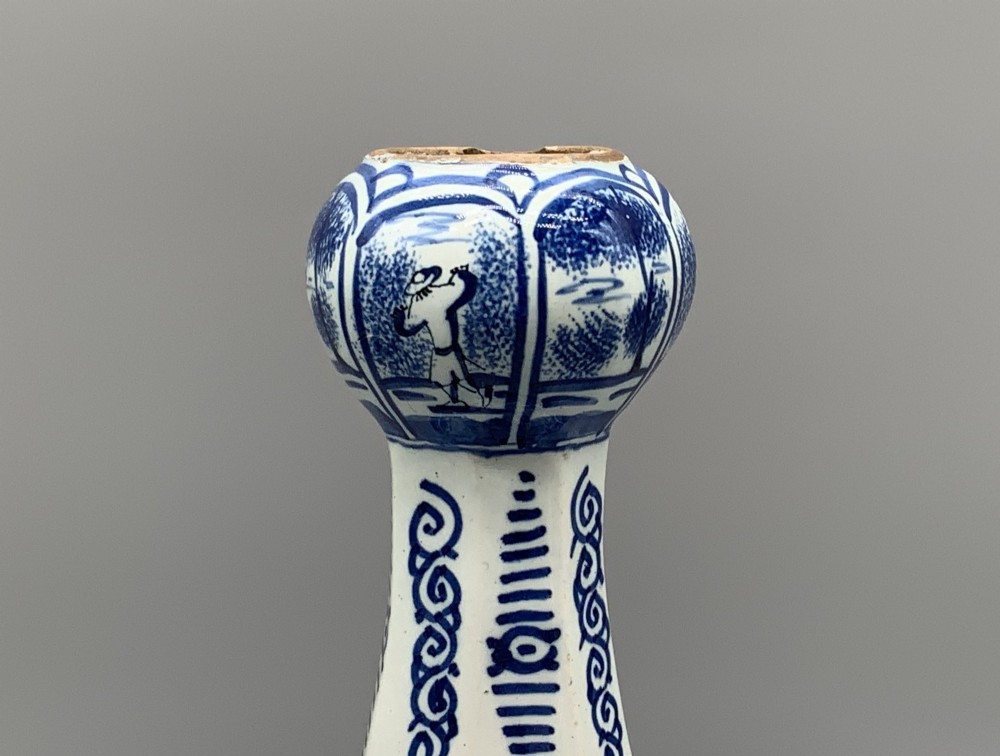 A 17th-century hexagonal Dutch Delft blue and white faience vase decorated with hand-painted chinoiserie figures and floral motifs. View V
