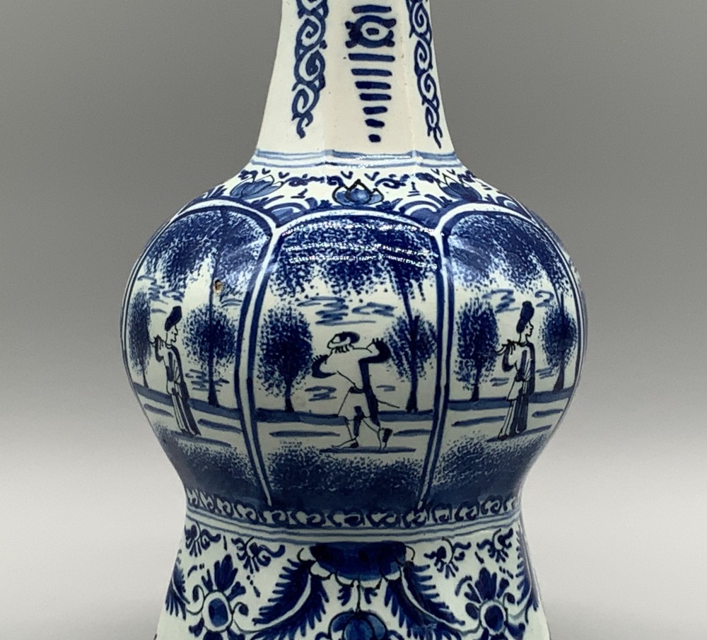 A 17th-century hexagonal Dutch Delft blue and white faience vase decorated with hand-painted chinoiserie figures and floral motifs. View VI