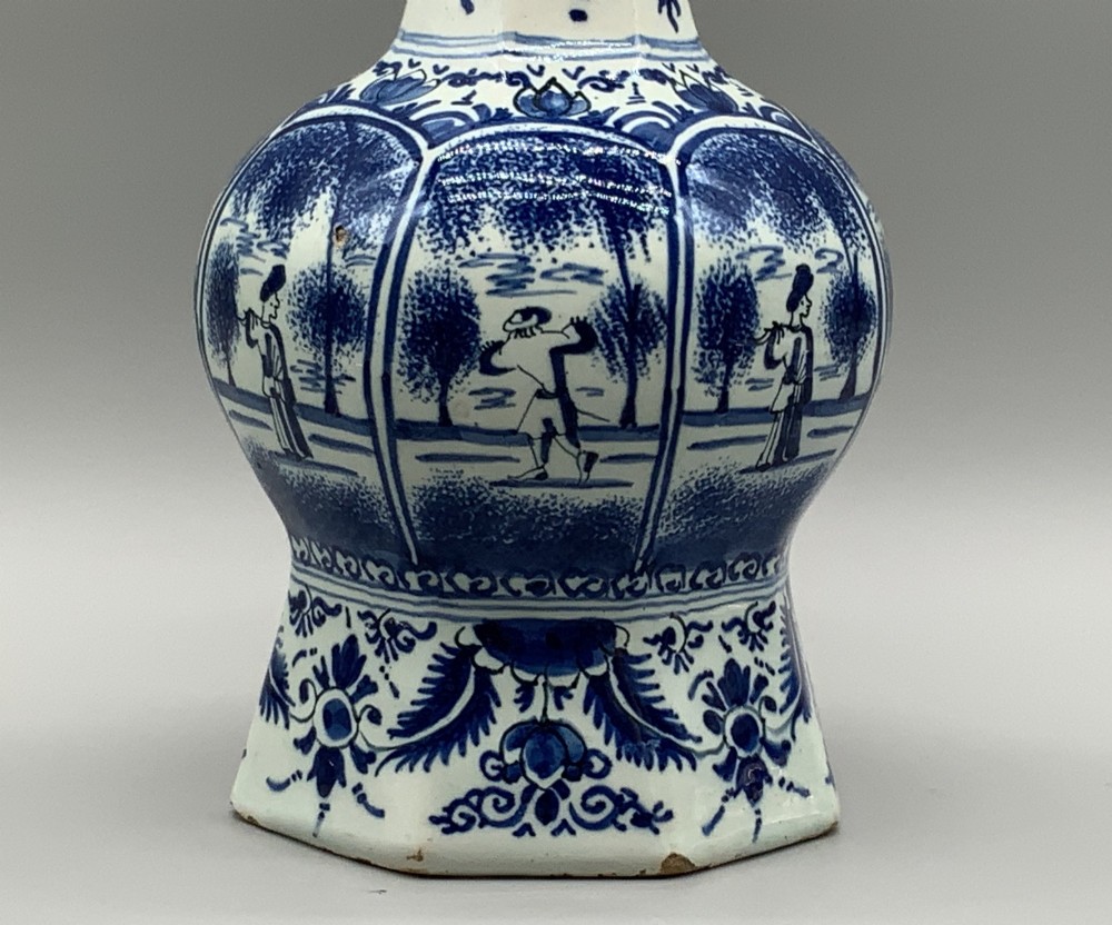 A 17th-century hexagonal Dutch Delft blue and white faience vase decorated with hand-painted chinoiserie figures and floral motifs. View VII