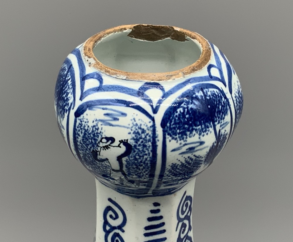 A 17th-century hexagonal Dutch Delft blue and white faience vase decorated with hand-painted chinoiserie figures and floral motifs. View VIII