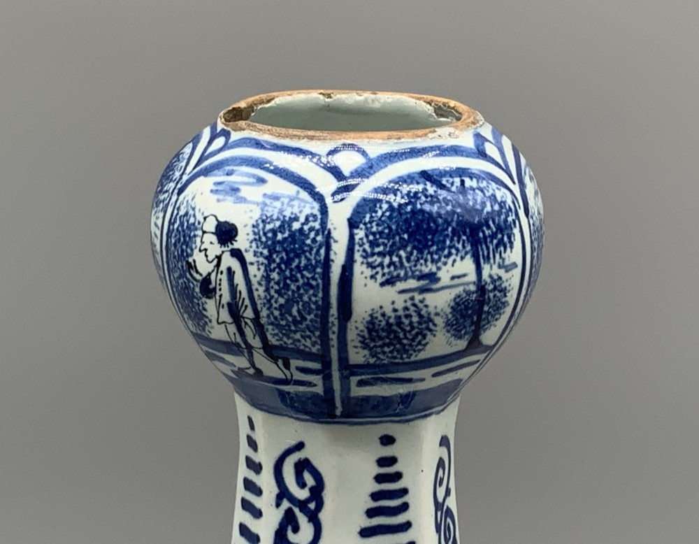 A 17th-century hexagonal Dutch Delft blue and white faience vase decorated with hand-painted chinoiserie figures and floral motifs. View IX
