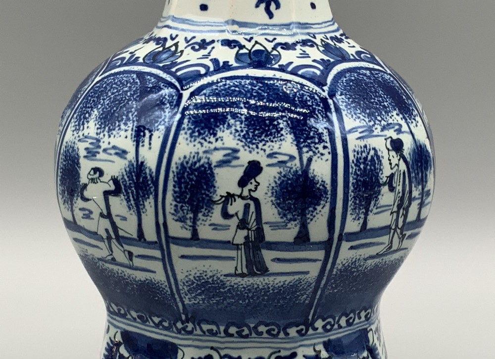 A 17th-century hexagonal Dutch Delft blue and white faience vase decorated with hand-painted chinoiserie figures and floral motifs. View XI