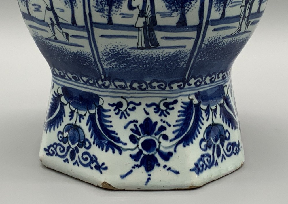 A 17th-century hexagonal Dutch Delft blue and white faience vase decorated with hand-painted chinoiserie figures and floral motifs. View XII