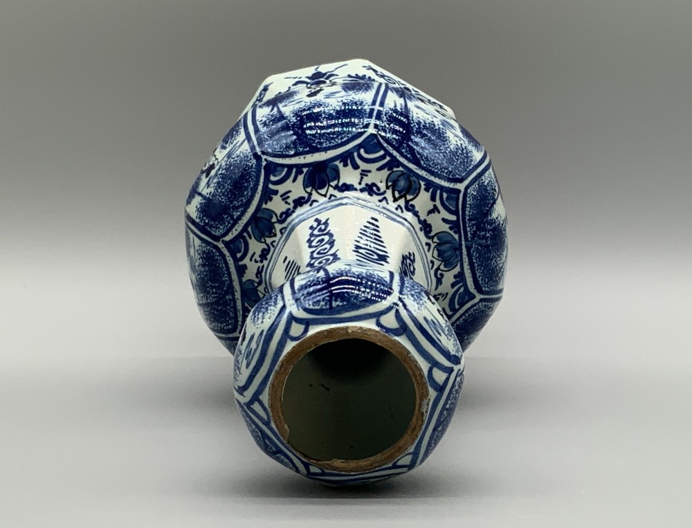 A 17th-century hexagonal Dutch Delft blue and white faience vase decorated with hand-painted chinoiserie figures and floral motifs. View XIV