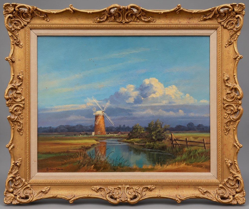 An oil painting depicting Horsey Mill set amidst the Norfolk Broads under a cloud-filled sky, presented in an elaborate gilded swept frame.