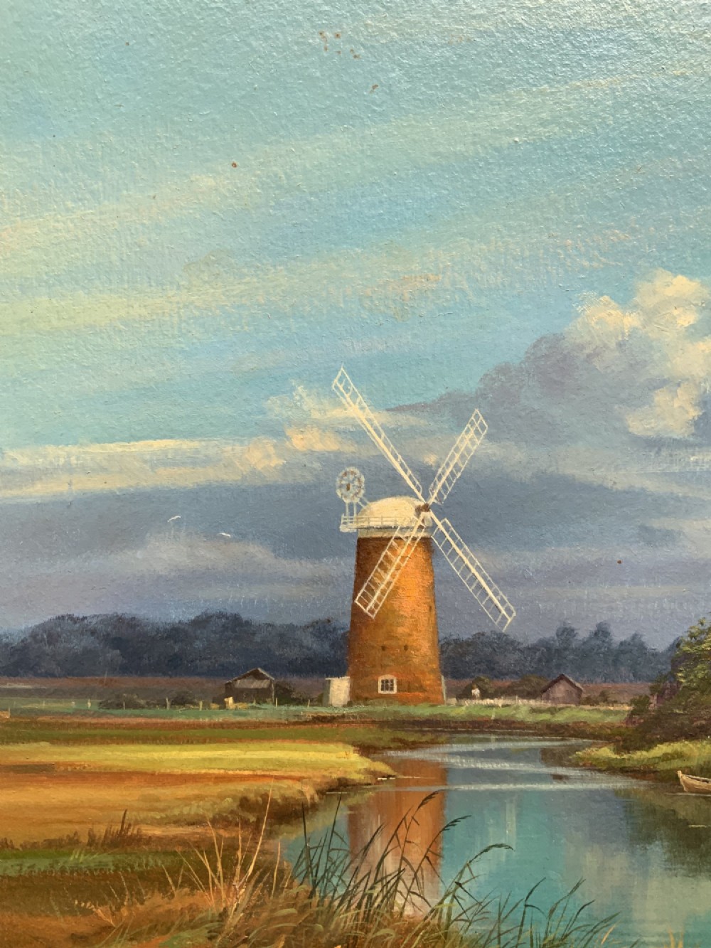 An oil painting depicting Horsey Mill set amidst the Norfolk Broads under a cloud-filled sky, presented in an elaborate gilded swept frame. View VIII